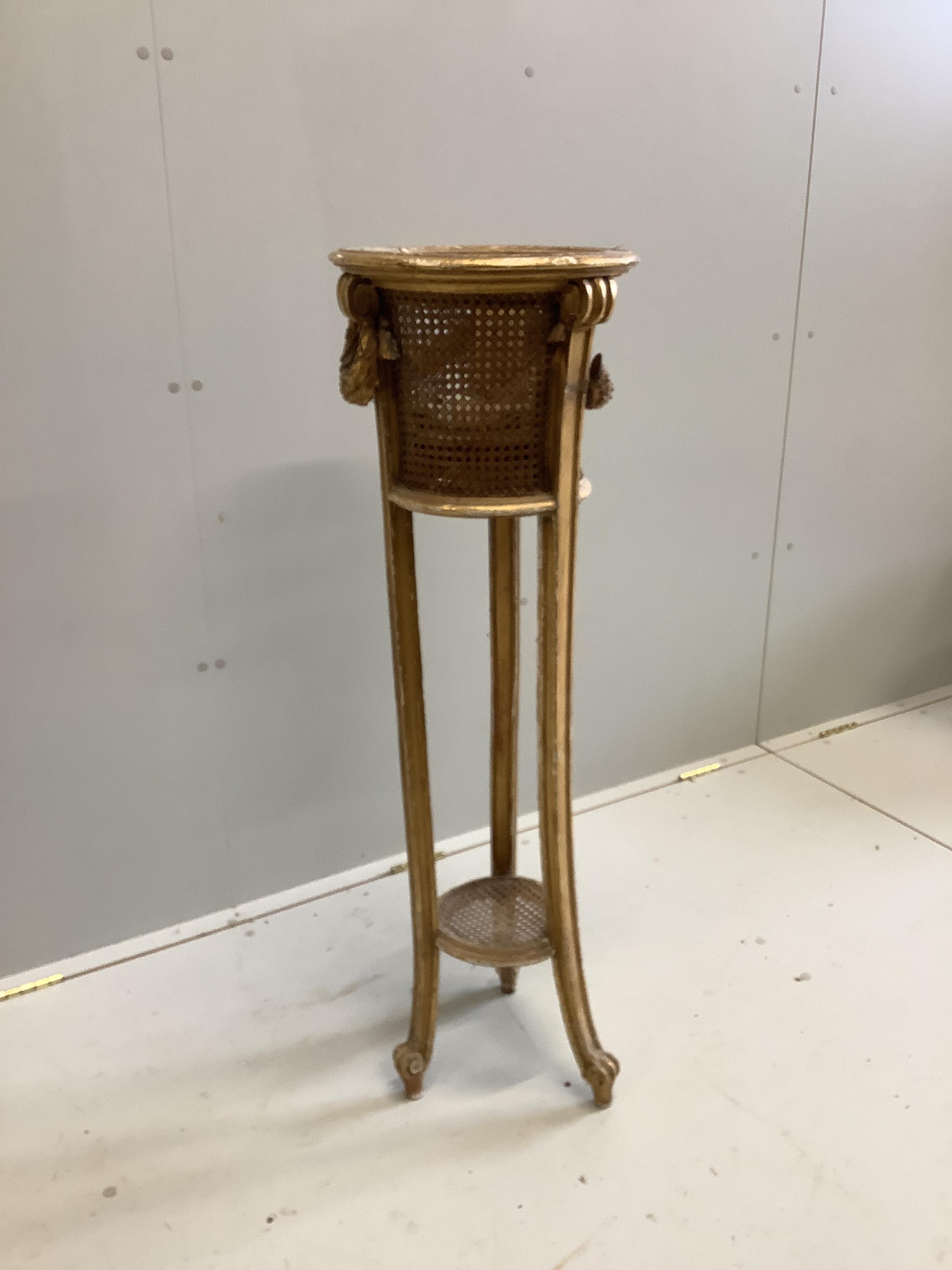 A carved giltwood and composition caned jardiniere stand, diameter 34cm, height 110cm (a.f.)